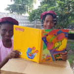 Children read books donated to Books for Africa