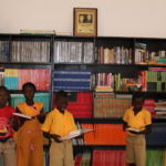 Children read books donated to Books for Africa